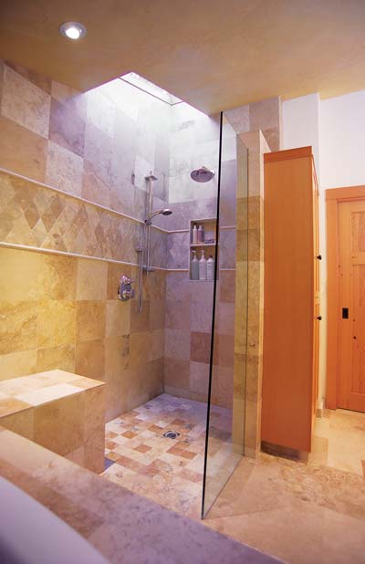 
The spacious bathroom includes Travertine stone tiles and recycled Douglas fir cabinets, trim and interior doors.
